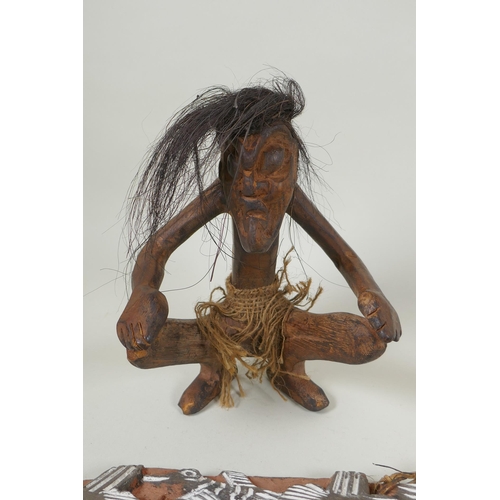 280 - A New Guinea carved wood primitive figure together with a carved New Guinea Kambot storyboard panel,... 