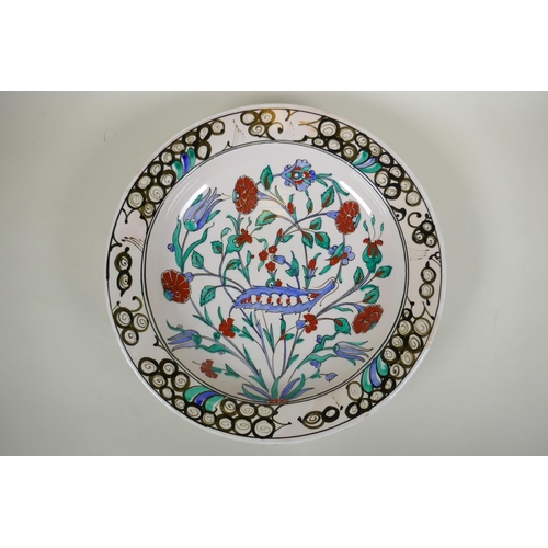 283 - An Iznik style Greek pottery charger by Icaro Rodi with hand painted floral decoration, and another ... 