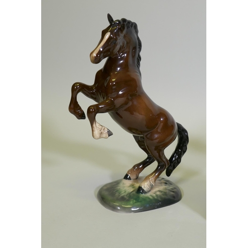 31 - A Beswick figure of a leaping horse, No 1014, another of a cart horse, and a Beswick /Royal Doulton ... 