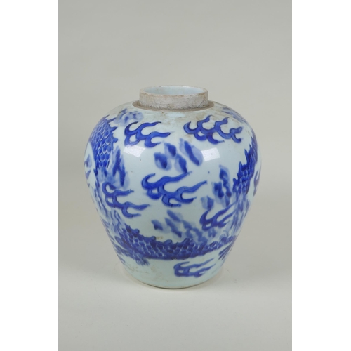 33 - A Chinese C19th blue and white porcelain ginger jar decorated with a dragon chasing the flaming pear... 