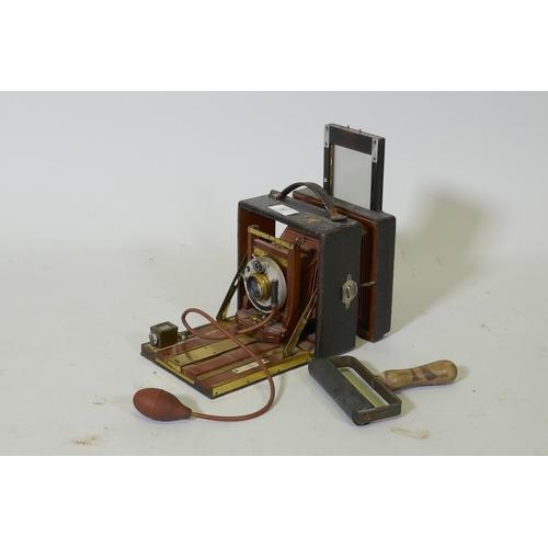 37 - A Victorian bellows camera mahogany with brass mounts, in leather covered case, Koilos shutter and l... 