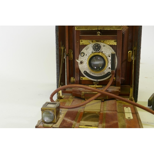 37 - A Victorian bellows camera mahogany with brass mounts, in leather covered case, Koilos shutter and l... 