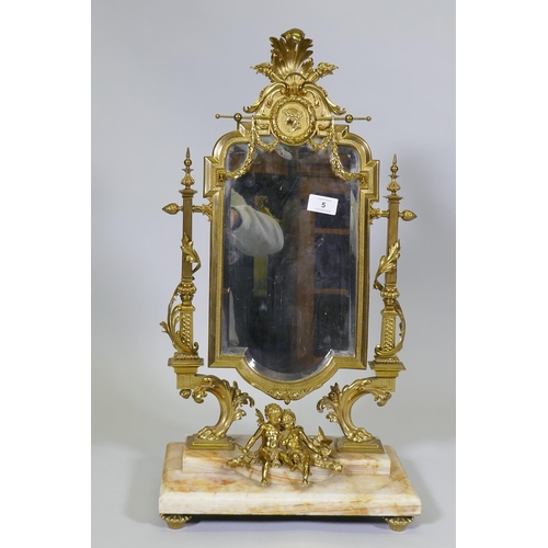 5 - A C19th French ormolu toilet mirror on an onyx base, decorated with putti, swags and torcheres, 66cm... 