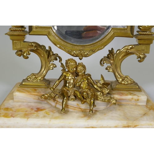 5 - A C19th French ormolu toilet mirror on an onyx base, decorated with putti, swags and torcheres, 66cm... 