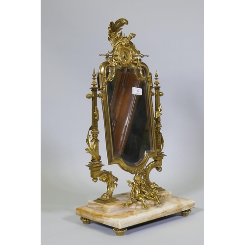 5 - A C19th French ormolu toilet mirror on an onyx base, decorated with putti, swags and torcheres, 66cm... 