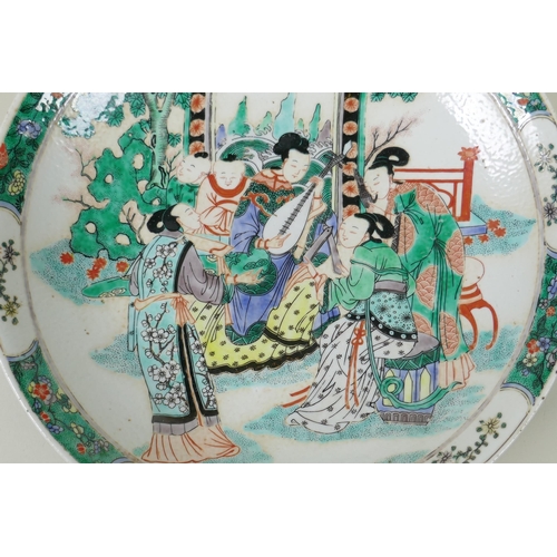 50 - A Chinese KangXi style famille vert porcelain charger, decorated with women playing music, mark to b... 