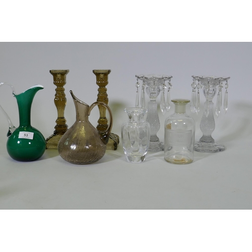 53 - A pair of pressed glass candlesticks, 25cm high, a pair of lustres, AF lacks some drops, glass ewer ... 