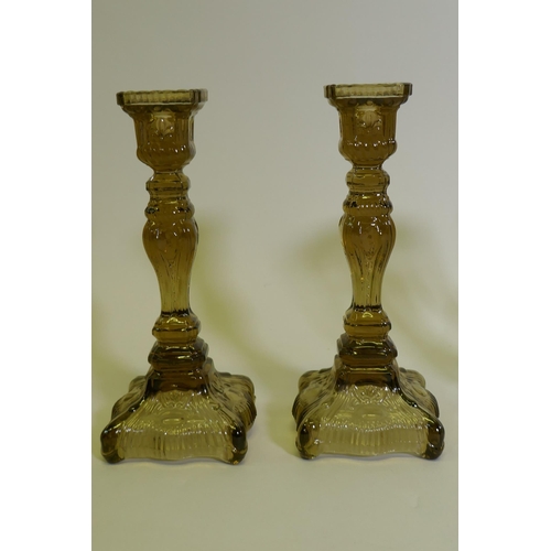 53 - A pair of pressed glass candlesticks, 25cm high, a pair of lustres, AF lacks some drops, glass ewer ... 