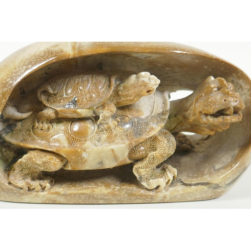 56 - A Chinese reconstituted stone carving of a tortoise and its young, 17cm long