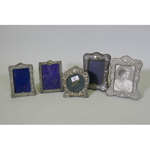 601 - Five antique hallmarked silver photo frames with repousse decoration