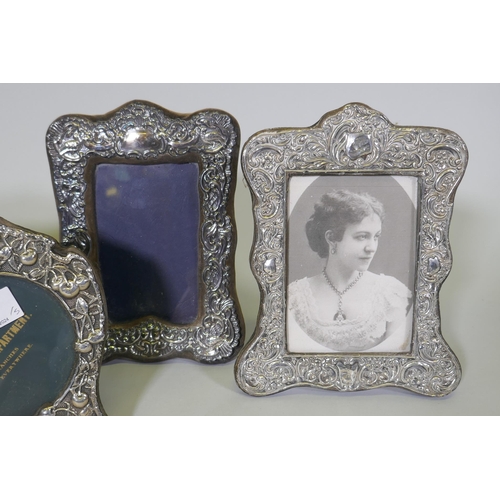 601 - Five antique hallmarked silver photo frames with repousse decoration