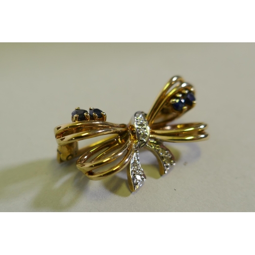 610 - A 9ct gold bow shaped brooch inset with diamonds, 2.5cm wide, 3.6g