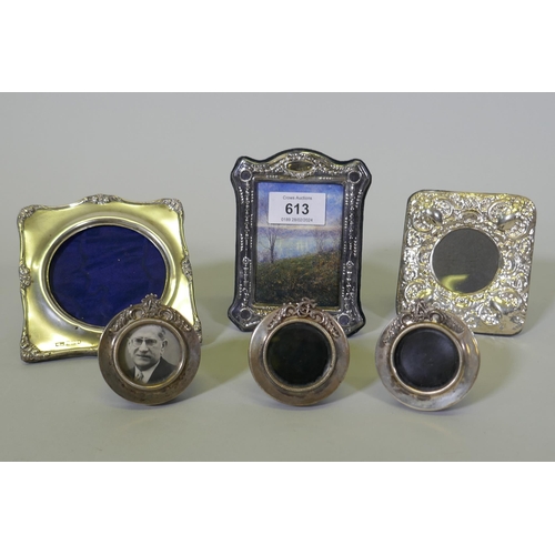 613 - Three miniature silver photo frames with monogram crests, aperture 3.5cm diameter, and three others