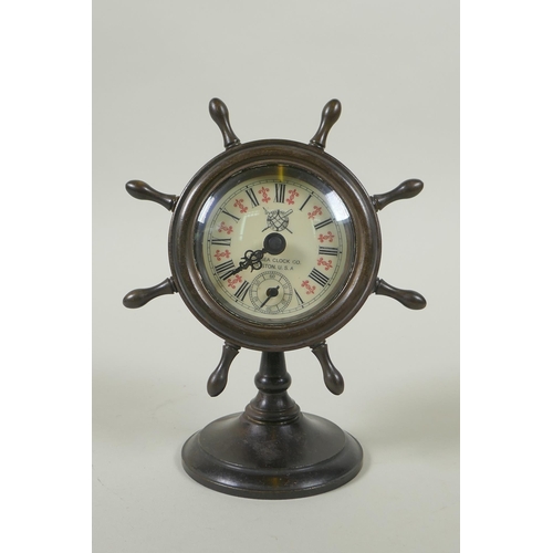 616 - A bronze desk clock in the form of a ship's wheel, the dial with Roman numerals and smaller subsidia... 