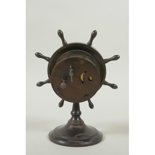 616 - A bronze desk clock in the form of a ship's wheel, the dial with Roman numerals and smaller subsidia... 