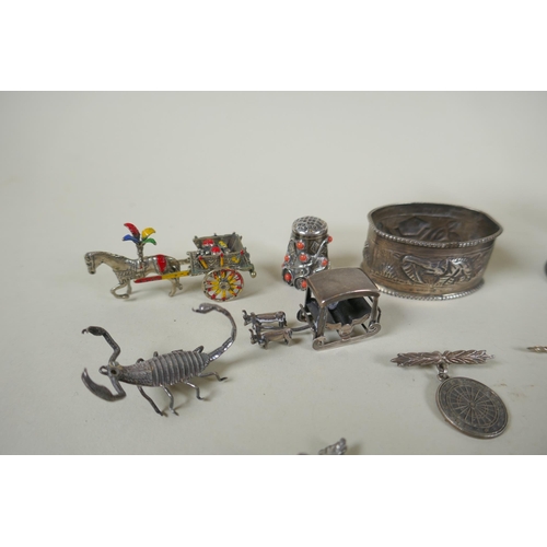 618 - A quantity of silver items to include belt buckles, napkin rings, cups, knife rests, etd, 230g, and ... 