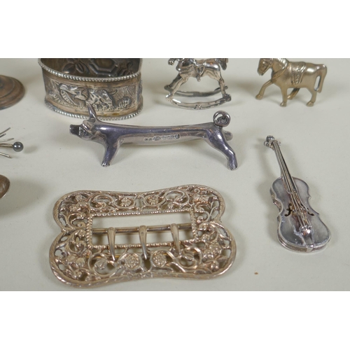 618 - A quantity of silver items to include belt buckles, napkin rings, cups, knife rests, etd, 230g, and ... 