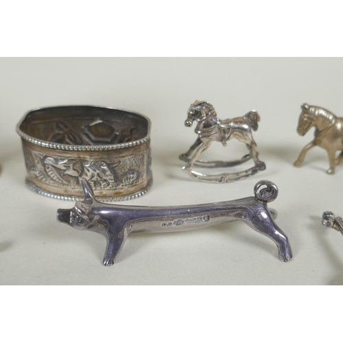 618 - A quantity of silver items to include belt buckles, napkin rings, cups, knife rests, etd, 230g, and ... 