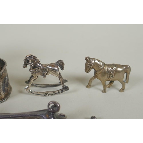 618 - A quantity of silver items to include belt buckles, napkin rings, cups, knife rests, etd, 230g, and ... 