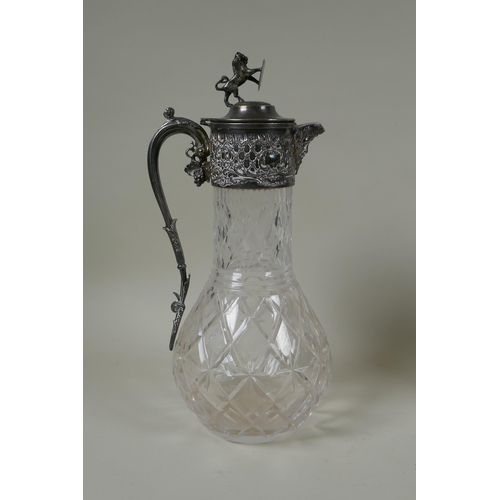 621 - An antique silver plated and cut glass claret jug with a rampant lion knop, and a Walker and Hall si... 