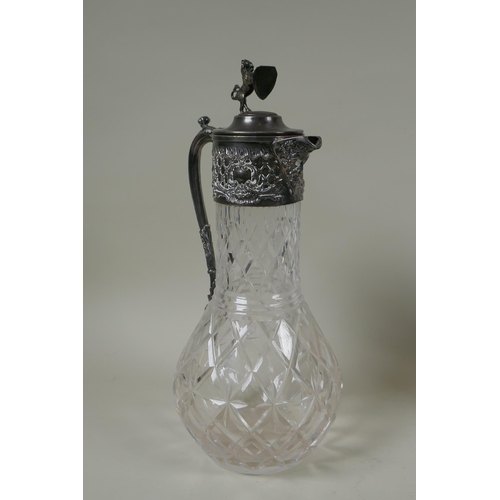 621 - An antique silver plated and cut glass claret jug with a rampant lion knop, and a Walker and Hall si... 