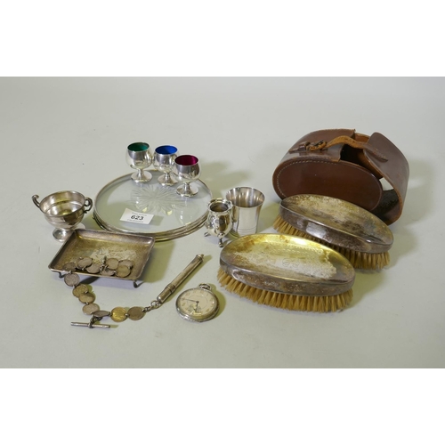 623 - A hallmarked silver pin tray, cups and beaker and cut glass coaster with silver mount, 16cm diameter... 