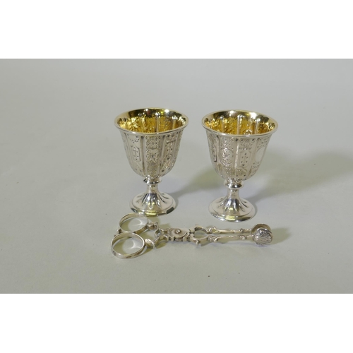 624 - A pair of hallmarked silver gift egg cups with Gothic style decoration, marked John Samuel Hunt, Lon... 