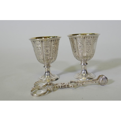 624 - A pair of hallmarked silver gift egg cups with Gothic style decoration, marked John Samuel Hunt, Lon... 