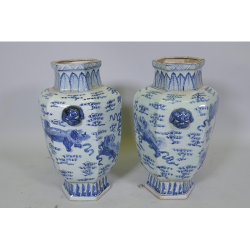 63 - A pair of Chinese blue and white per hexagonal vases with two lion mask handles and kylin decoration... 