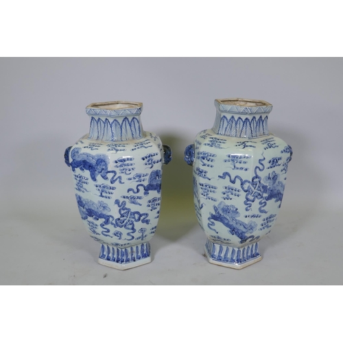 63 - A pair of Chinese blue and white per hexagonal vases with two lion mask handles and kylin decoration... 