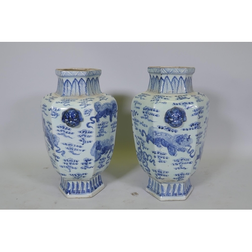 63 - A pair of Chinese blue and white per hexagonal vases with two lion mask handles and kylin decoration... 