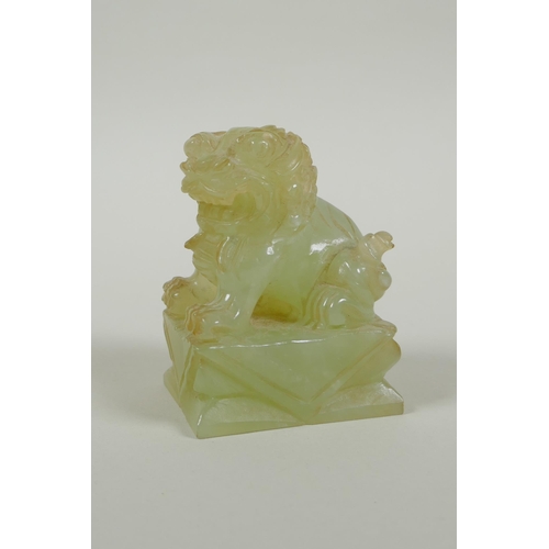 65 - A Chinese carved green jade temple lion, 7cm high