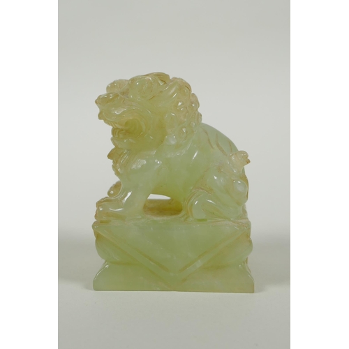 65 - A Chinese carved green jade temple lion, 7cm high