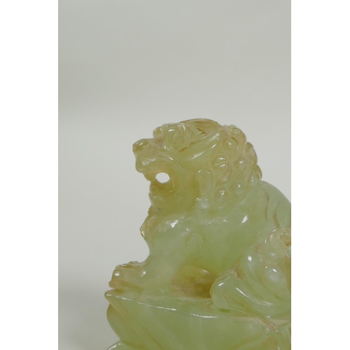 65 - A Chinese carved green jade temple lion, 7cm high