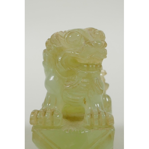 65 - A Chinese carved green jade temple lion, 7cm high