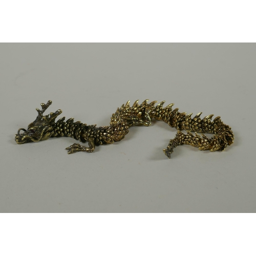 66 - A Japanese Jizai style bronze okimono dragon, with articulated body and legs, 23cm long