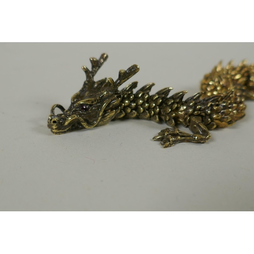 66 - A Japanese Jizai style bronze okimono dragon, with articulated body and legs, 23cm long