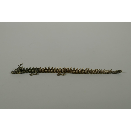 66 - A Japanese Jizai style bronze okimono dragon, with articulated body and legs, 23cm long