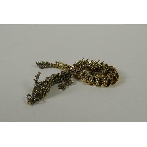 66 - A Japanese Jizai style bronze okimono dragon, with articulated body and legs, 23cm long