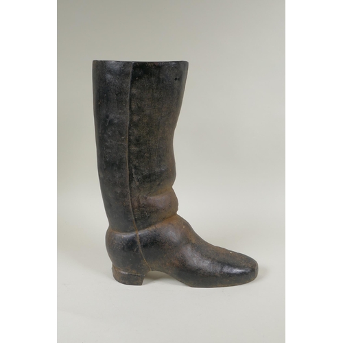 67 - A painted cast iron door stop in the form of a riding boot, 36cm high