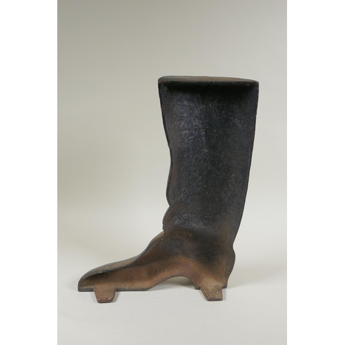 67 - A painted cast iron door stop in the form of a riding boot, 36cm high