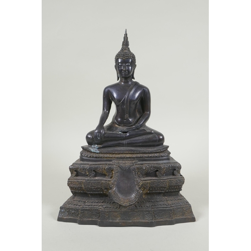 69 - A Thai bronze figure of Buddha seated on a tiered throne,