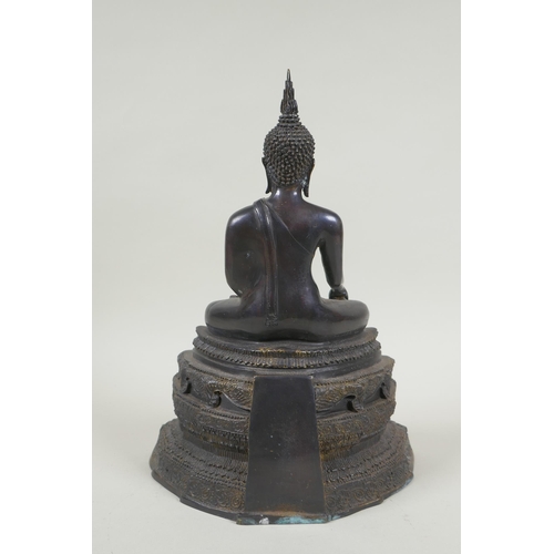 69 - A Thai bronze figure of Buddha seated on a tiered throne,