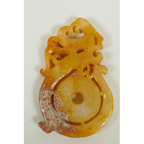 71 - A Chinese archaic style carved jade pendant with stylised dragon and phoenix decoration, 9 x 5cm