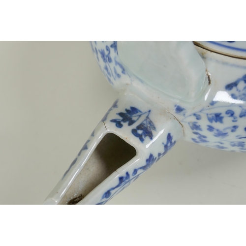 80 - An early C20th Japanese blue and white porcelain tea pot of squat form, with all over scrolling vine... 