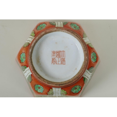 81 - A Chinese coral red ground porcelain bowl of hexagonal form, with polychrome enamel decoration of ca... 