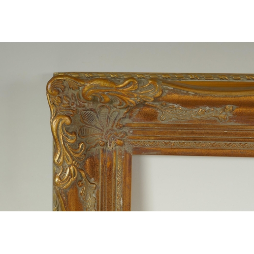 811 - A C20th gilt picture frame with scroll and floret decoration, rebate 51 x 41cm