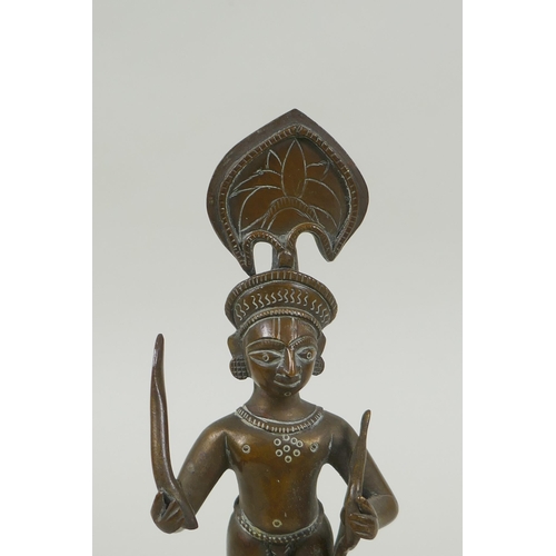 82 - An antique Indian bronze figure, with bow and short sword/septre, 19cm high