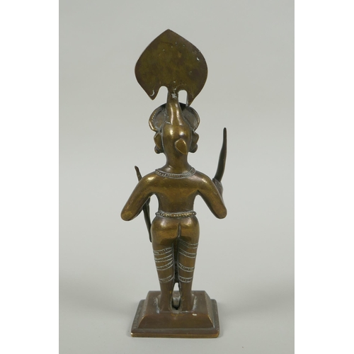 82 - An antique Indian bronze figure, with bow and short sword/septre, 19cm high