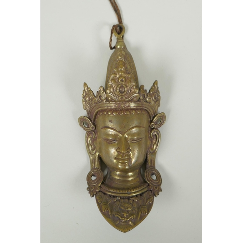 83 - A Nepalese bronze face bust of Indra, 22cm